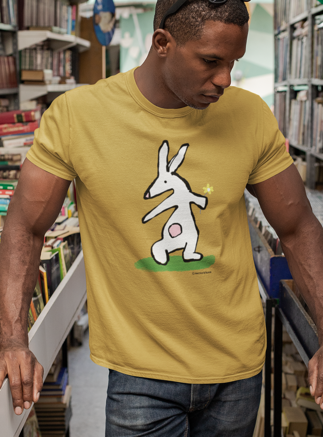 Bunny T-shirt - Young man wearing Illustrated bunny rabbit holding a flower design on a ochre colour vegan cotton t-shirt - Easter Bunny t-shirts by Hector and Bone