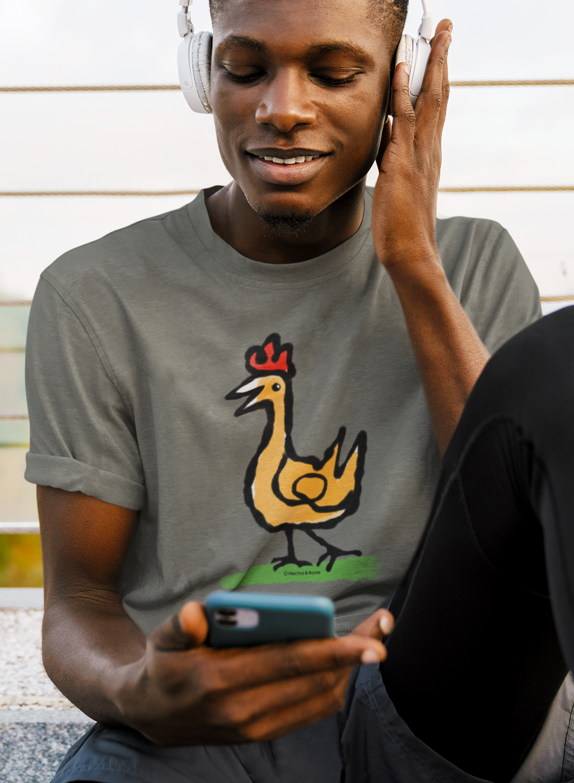 Happy Chicken T-shirt - Smiling young man wearing Illustrated Funny Chicken design on khaki colour vegan cotton t-shirts by Hector and Bone