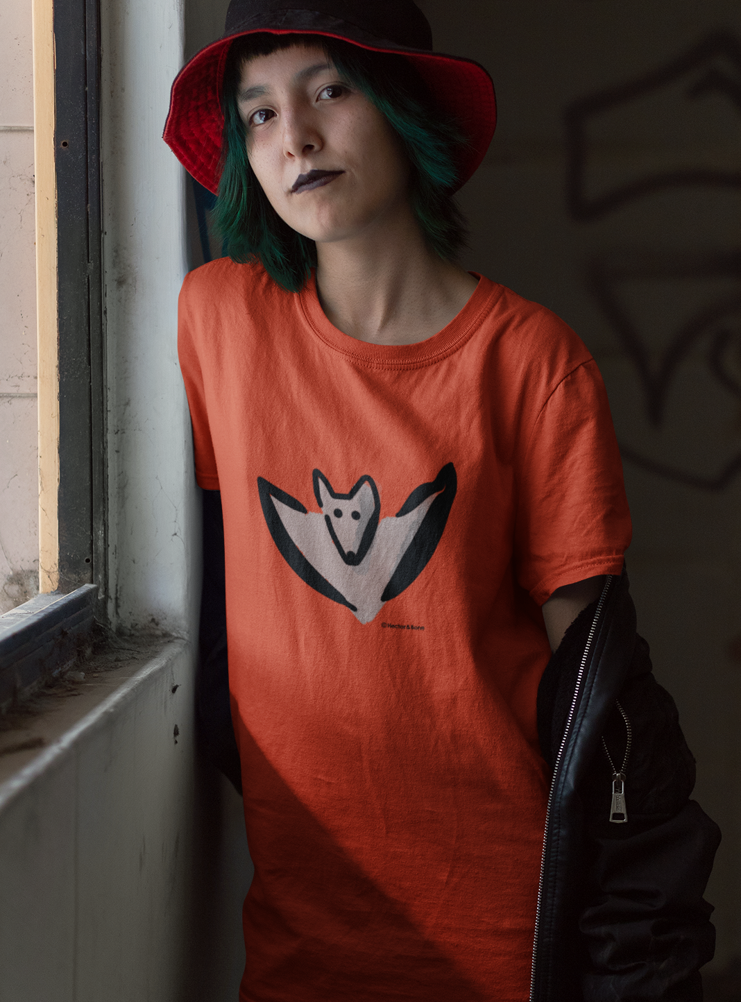 Bat T-shirt - Young woman wearing illustrated Bertie Bat T-shirt for Halloween in orange colour vegan cotton tshirts by Hector and Bone