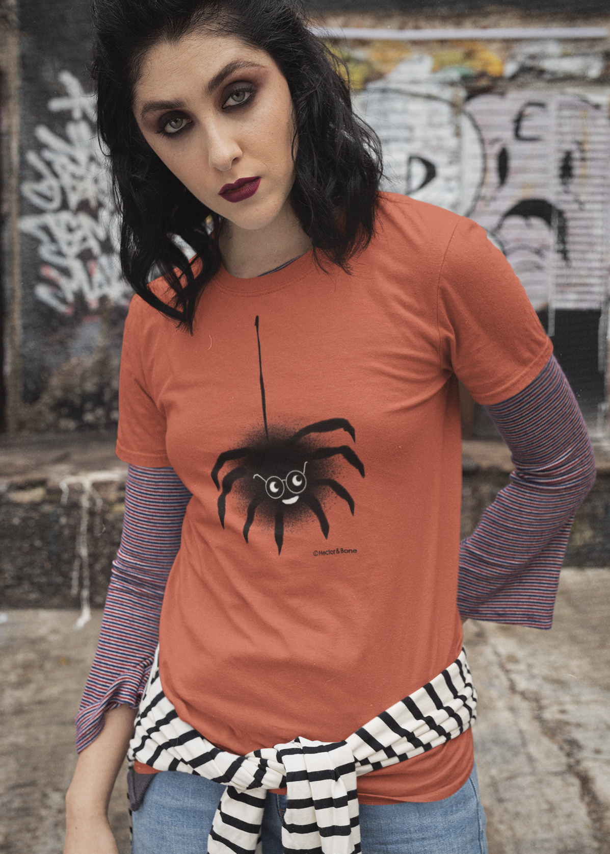 Spider T-shirt - A young goth girl wearing a cute Spectacled Spider original illustrated Halloween design on a Hector and Bone quality vegan orange colour cotton t-shirt