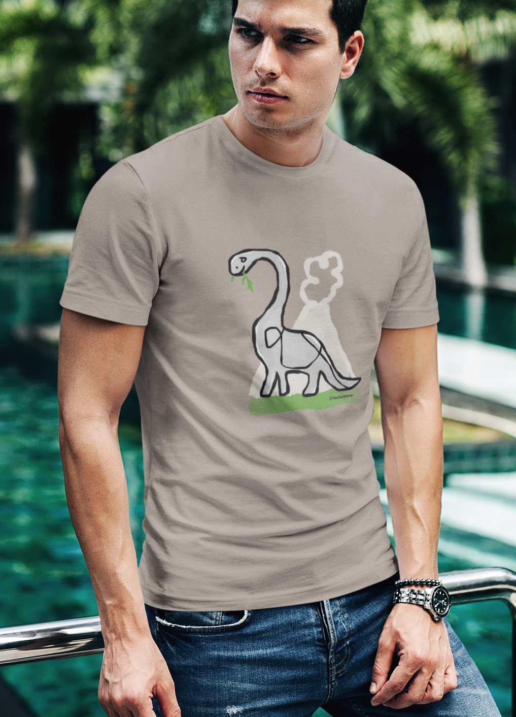 Young man wearing a Dinosaur T-shirt illustrated on a Desert Dust colour Brontosaurus Tshirt design by Hector and Bone