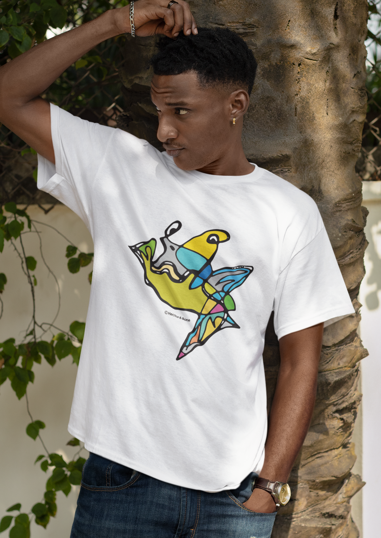 Young man wearing a Fish Boy modern art design on a white cotton vegan T-shirt by artist Hector and Bone