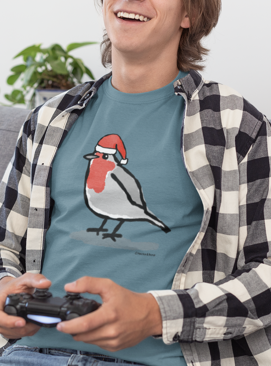 Young man relaxing at Xmas, wearing a illustrated Santa Christmas Robin T-shirt - Stargazer Blue colour vegan cotton Christmas T-shirts by Hector and Bone