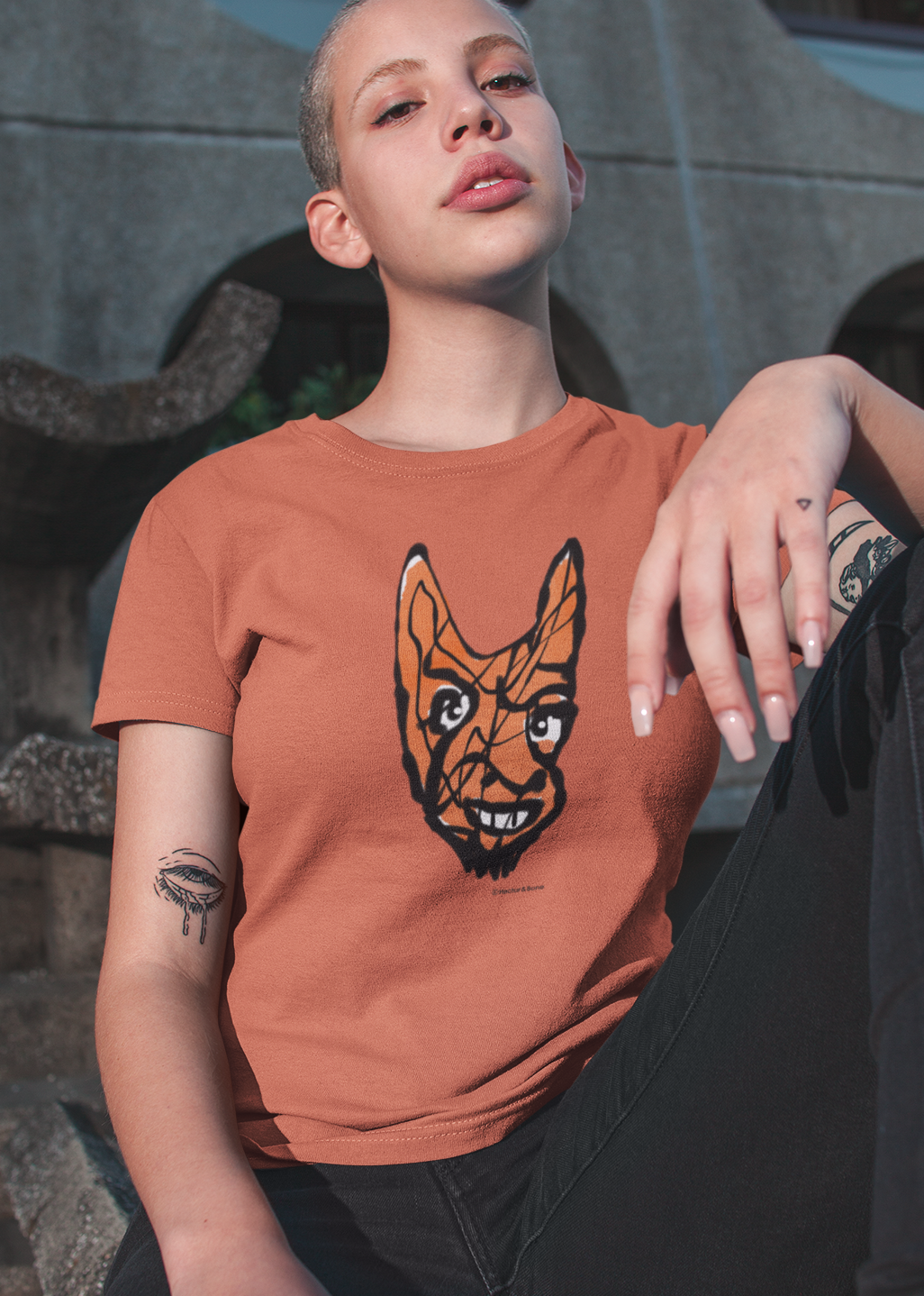 Devil T-shirt - Young woman wearing Cheeky Little Devil illustrated orange vegan cotton t-shirts by Hector and Bone