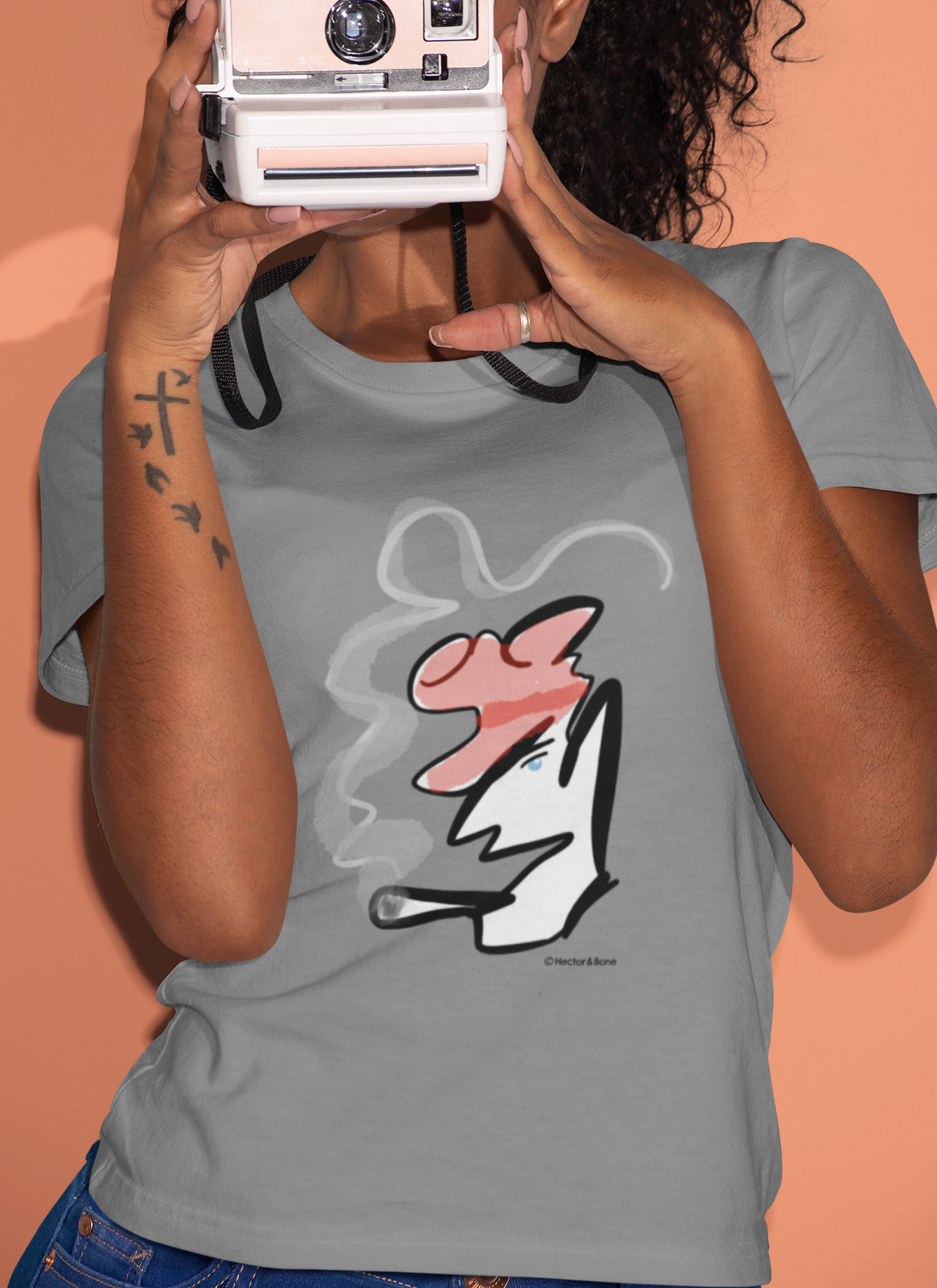 Woman wearing a stylised illustrated design of Parisian smoking man portrait on a Mid heather grey colour vegan cotton t-shirt by Hector and Bone