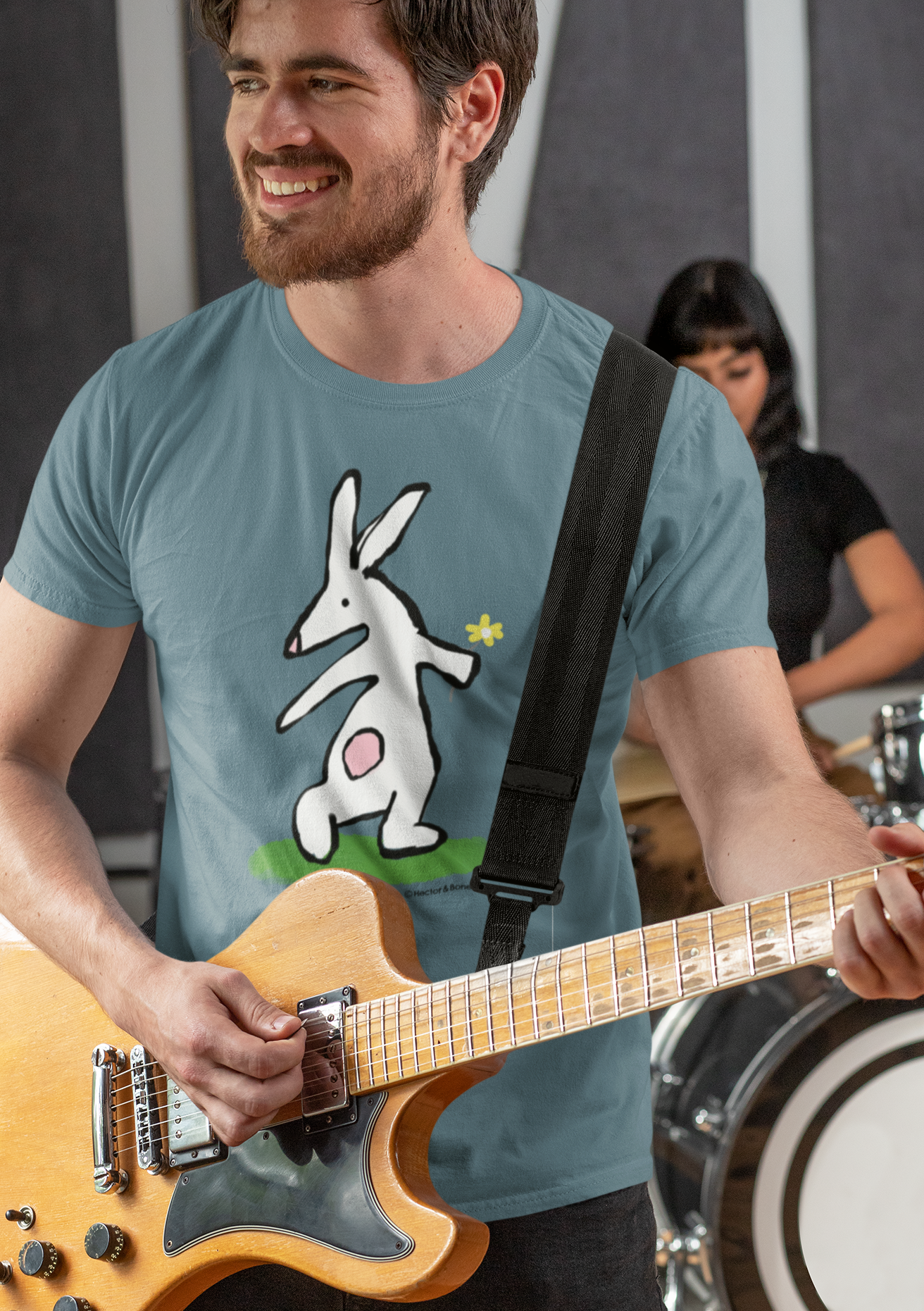 Bunny T-shirt - Guitarist man wearing Illustrated bunny rabbit holding a flower design on a Stargazer blue vegan cotton t-shirt - Easter Bunny t-shirts by Hector and Bone