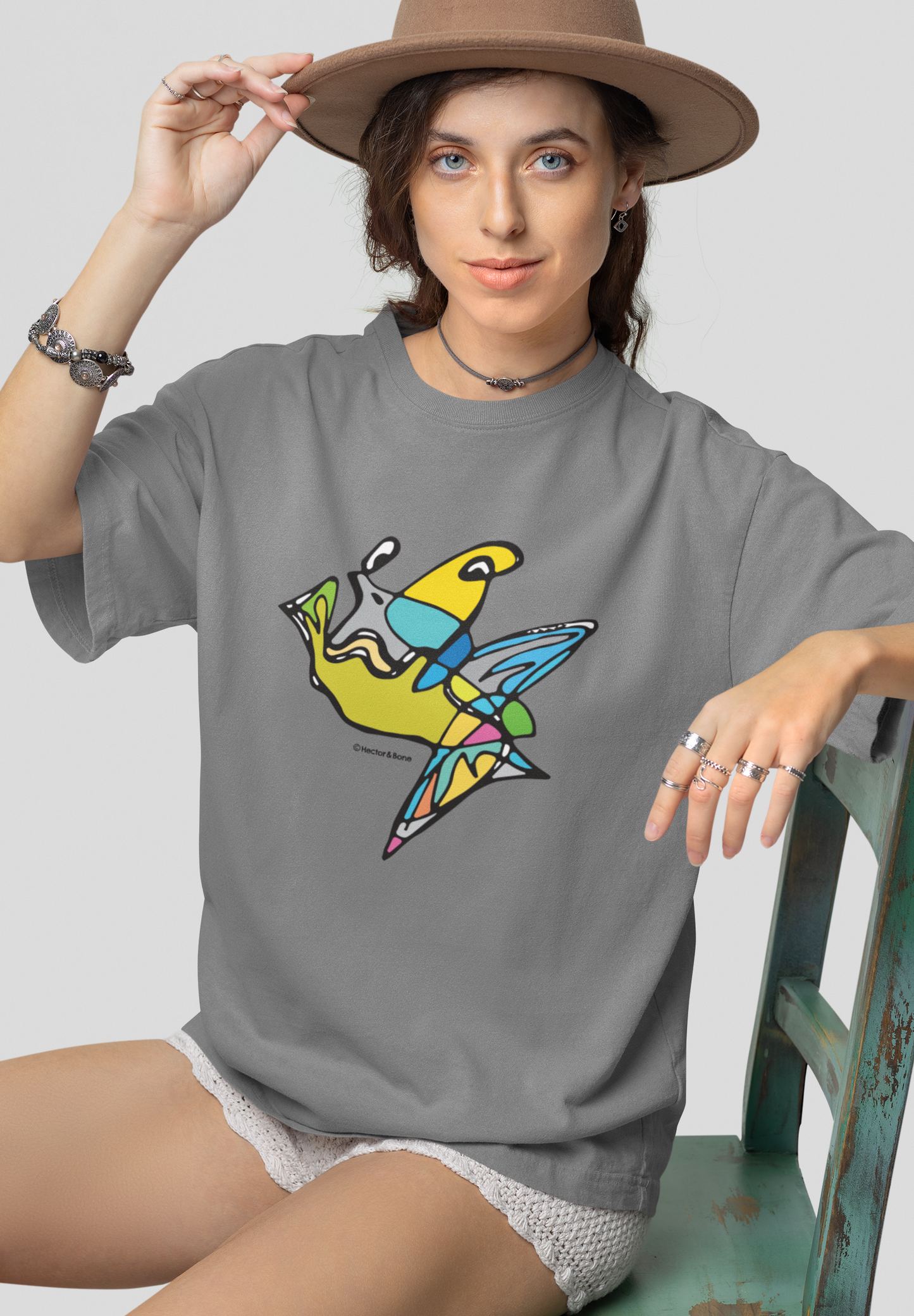 Young woman wearing a Fish Boy modern art design on a mid heather grey cotton vegan T-shirt by artist Hector and Bone