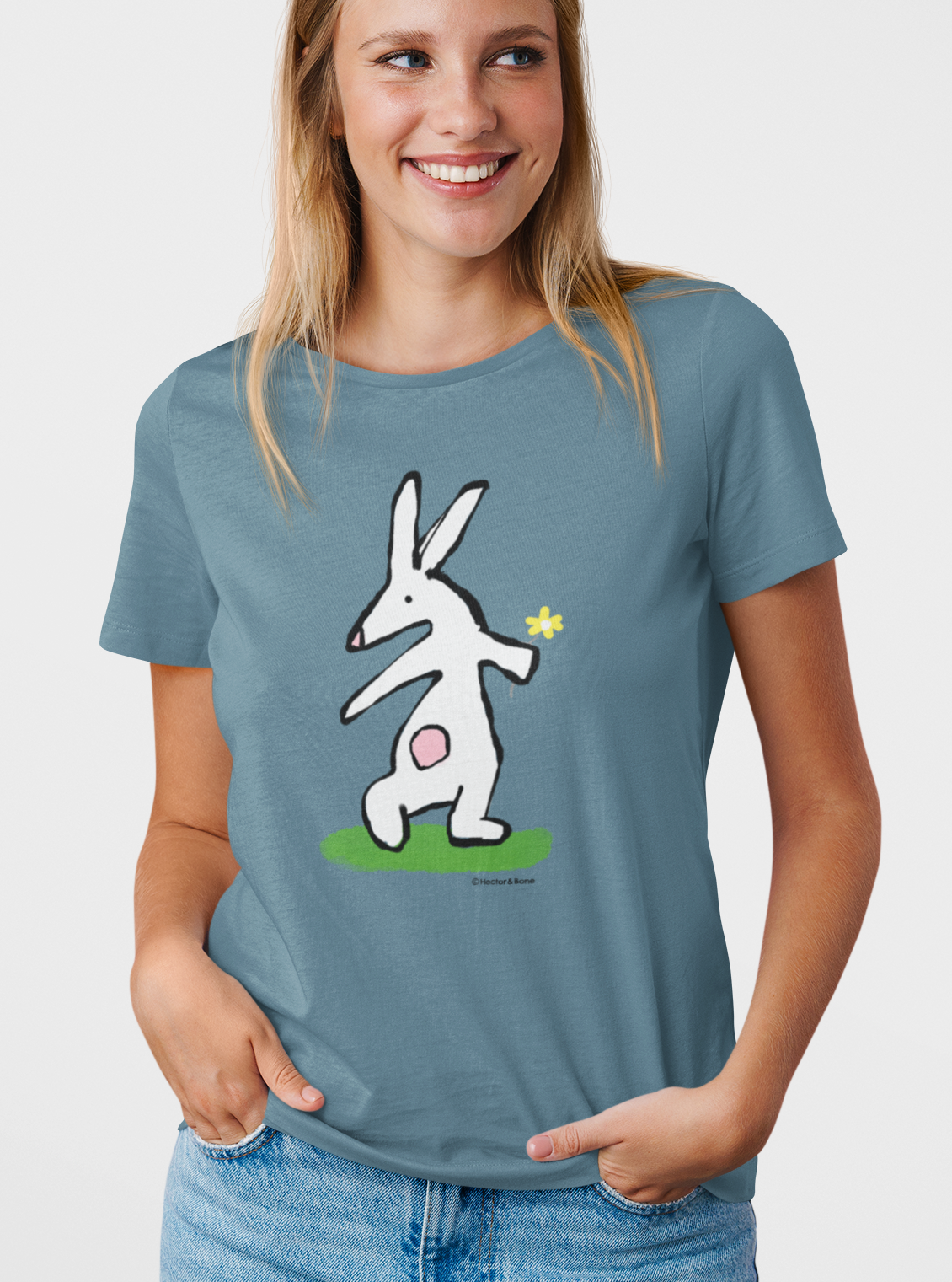 Bunny T-shirt - Young woman wearing Illustrated rabbit holding a flower design on a Stargazer blue vegan cotton t-shirt - Easter Bunny t-shirts by Hector and Bone