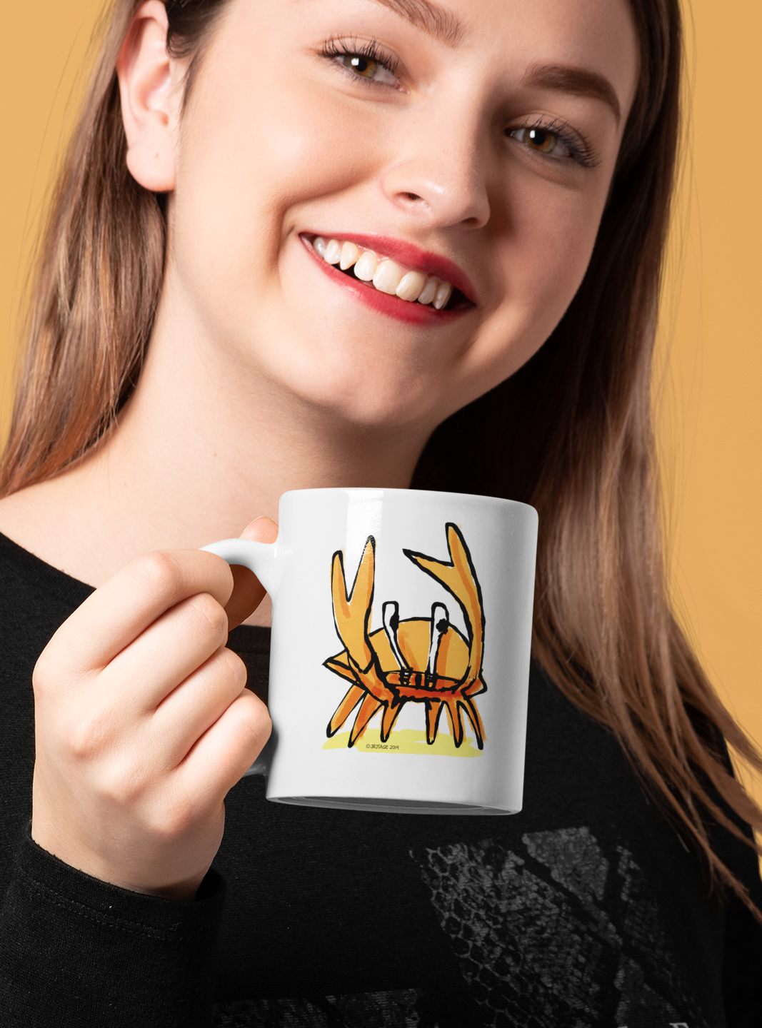 A young woman holding a White Ceramic Hector and Bone Mug with an illustration of a cute Angry Crab