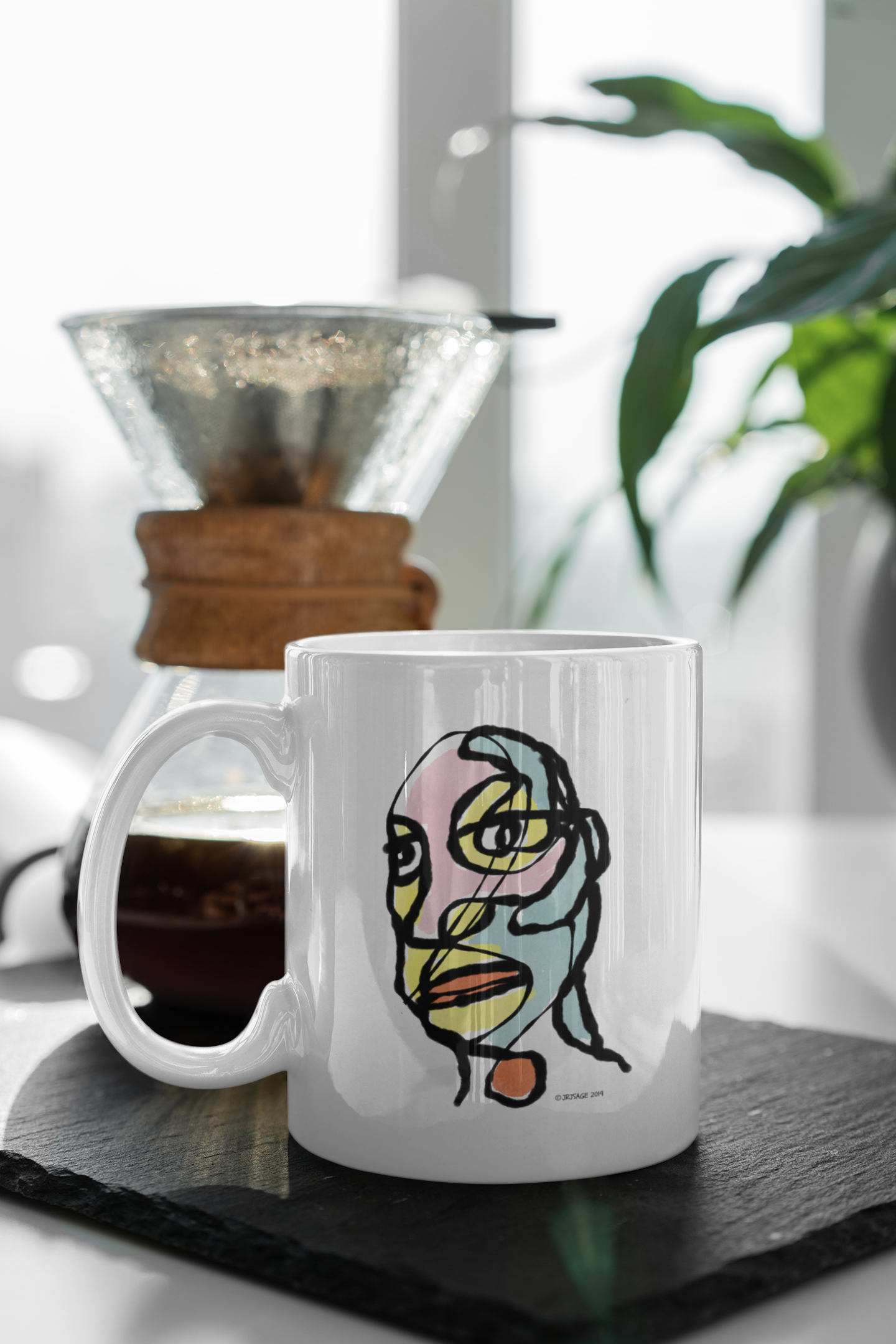 A White Ceramic Hector and Bone Mug with a quirky illustration of an arty abstract portrait