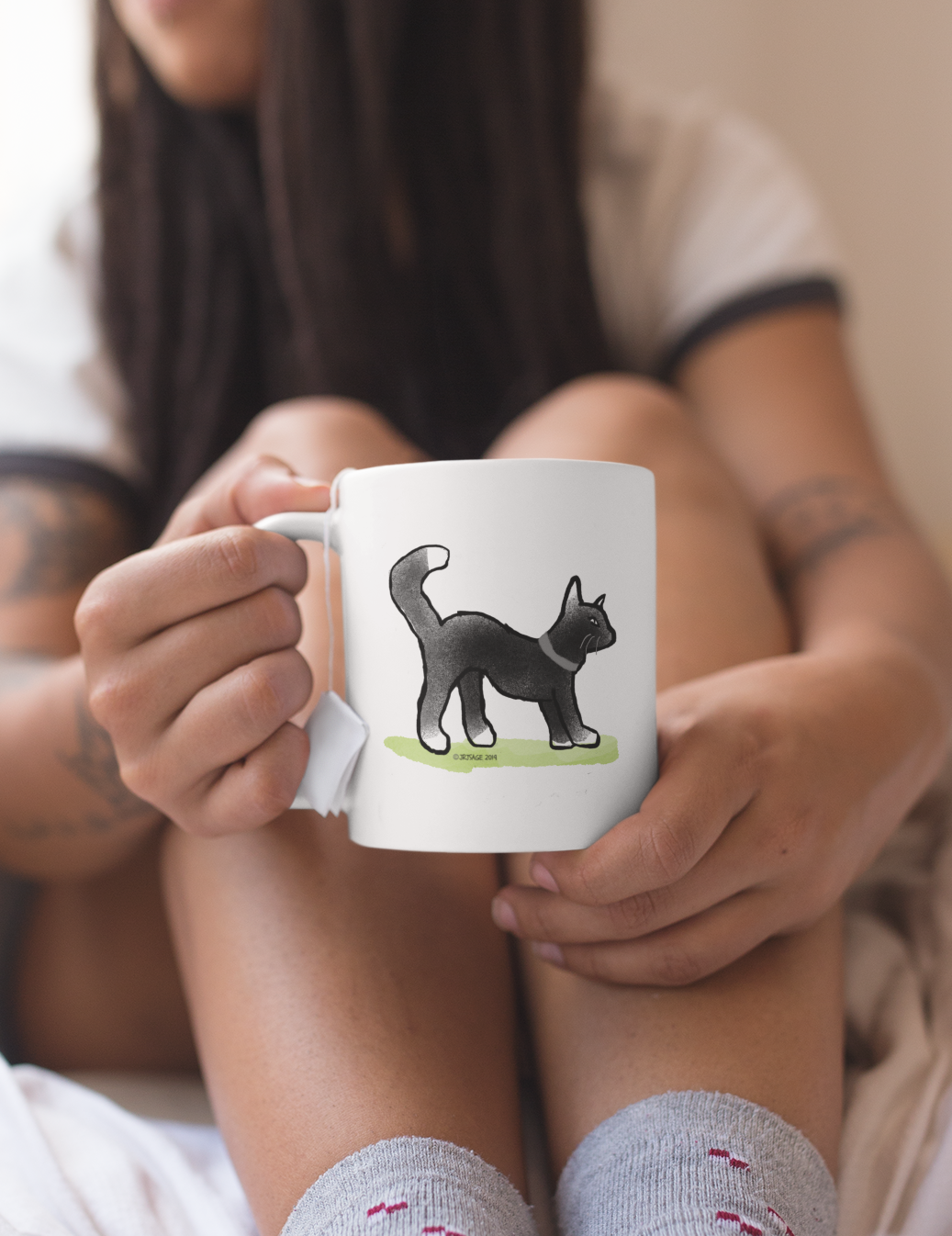 Black Cat Mug - Young woman holding a White Ceramic Hector and Bone coffee Mug with a cute Black Cat with white bits illustration