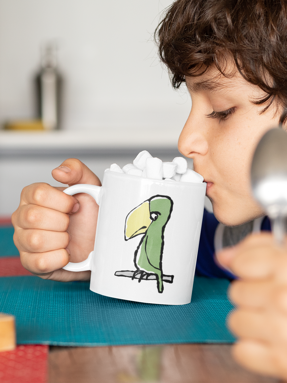Boy sips from a Funny Peter Parrot mug - Original Illustrated Parrot design on a coffee mug by Hector and Bone