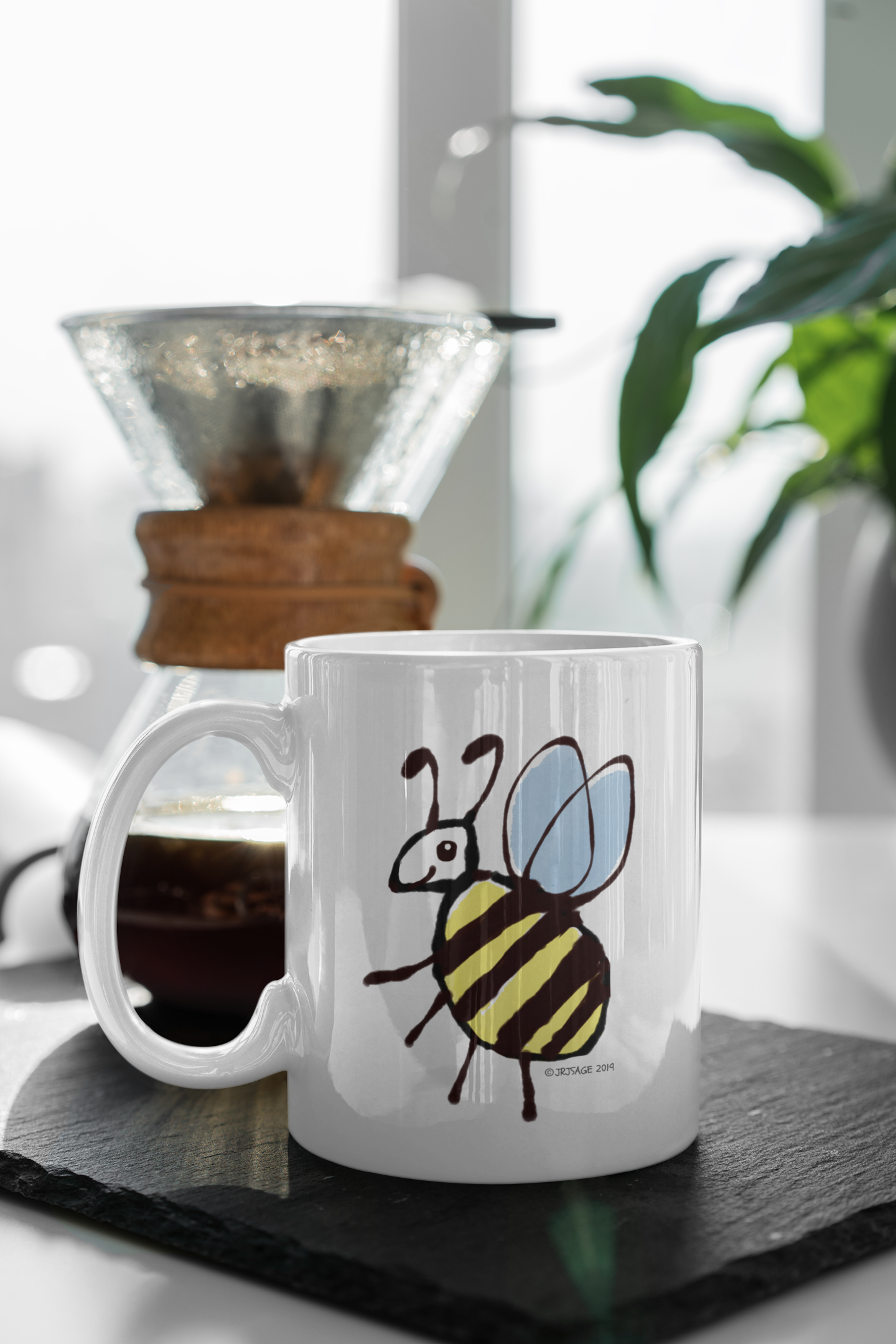 Cute Busy Bee design on a coffee mug by Hector and Bone on a table