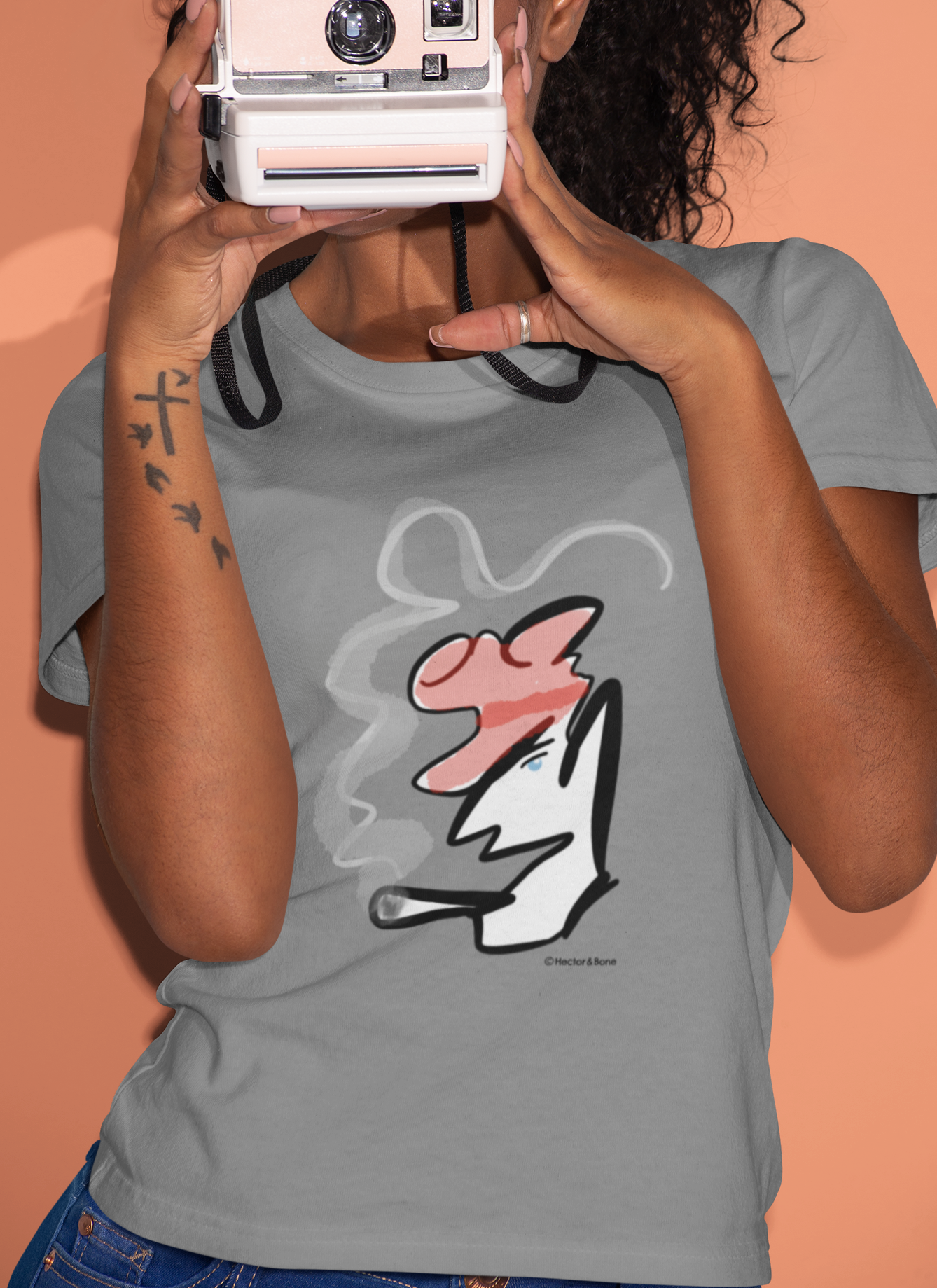 Young woman wearing a stylised illustrated design of Parisian smoking man portrait on a grey heather vegan cotton t-shirt by Hector and Bone