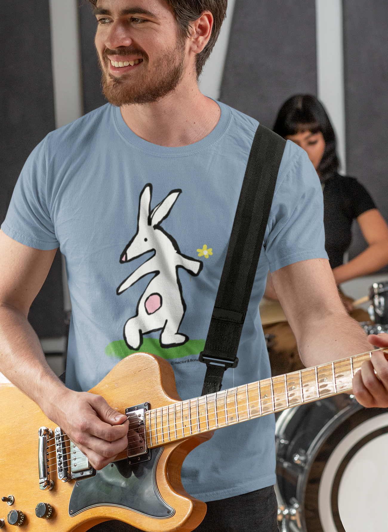 Bunny T-shirt - Guitarist man wearing Illustrated bunny rabbit holding a flower design on a mid heather blue vegan cotton t-shirt - Easter Bunny t-shirts by Hector and Bone