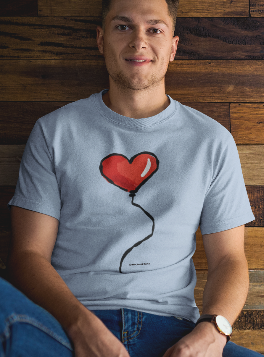 Happy young man wearing a Red Heart Balloon I Love you T-shirt design printed on a sky blue colour vegan cotton t-shirt by Hector and Bone