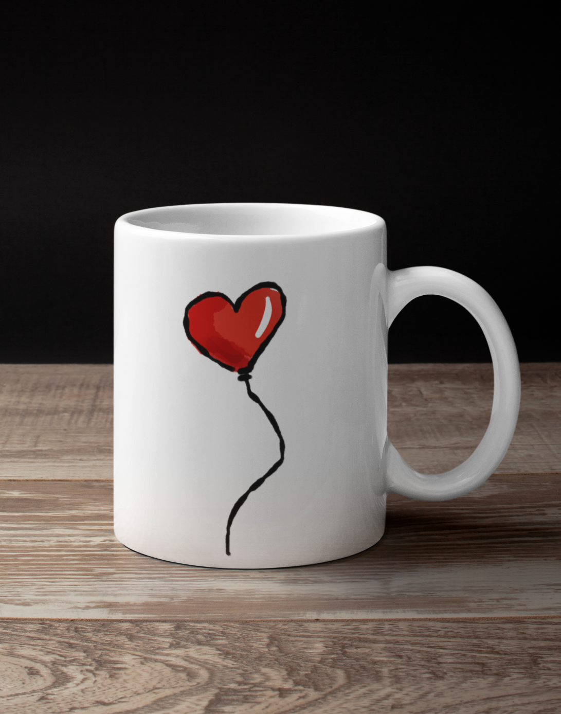 Red Heart Balloon I Love you illustration by Hector and Bone printed on a quality ceramic coffee mug on a wooden table