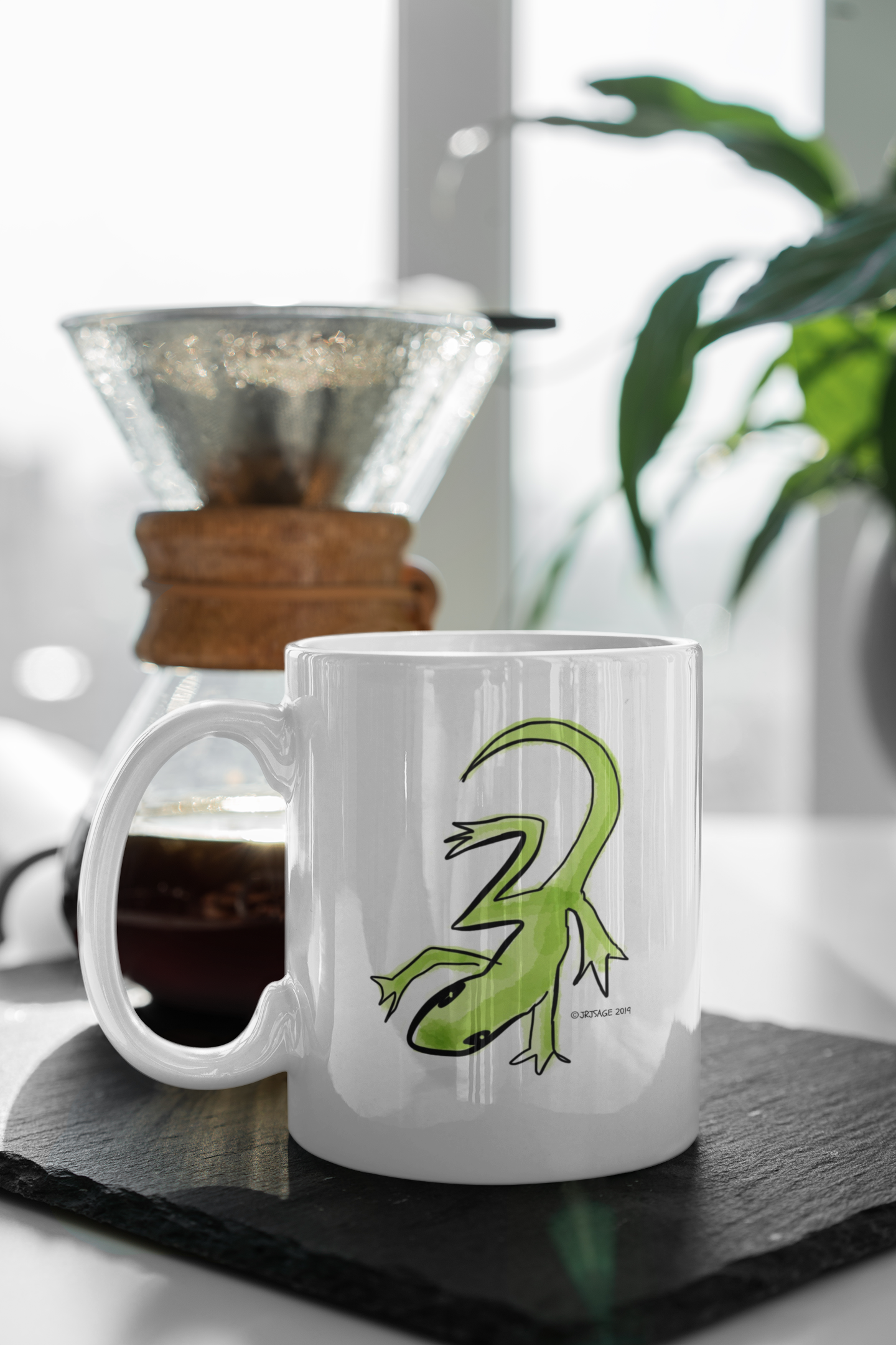 Lounge Lizard Mug - Green Lizard Mugs - Illustrated Gekko design by Hector and Bone on a table