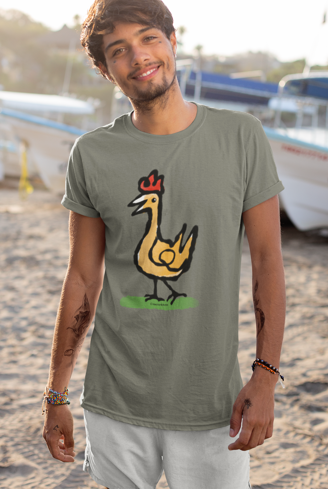 Happy Chicken T-shirt - Smiling young man wearing Illustrated Funny Chicken design on khaki colour vegan cotton t-shirts by Hector and Bone