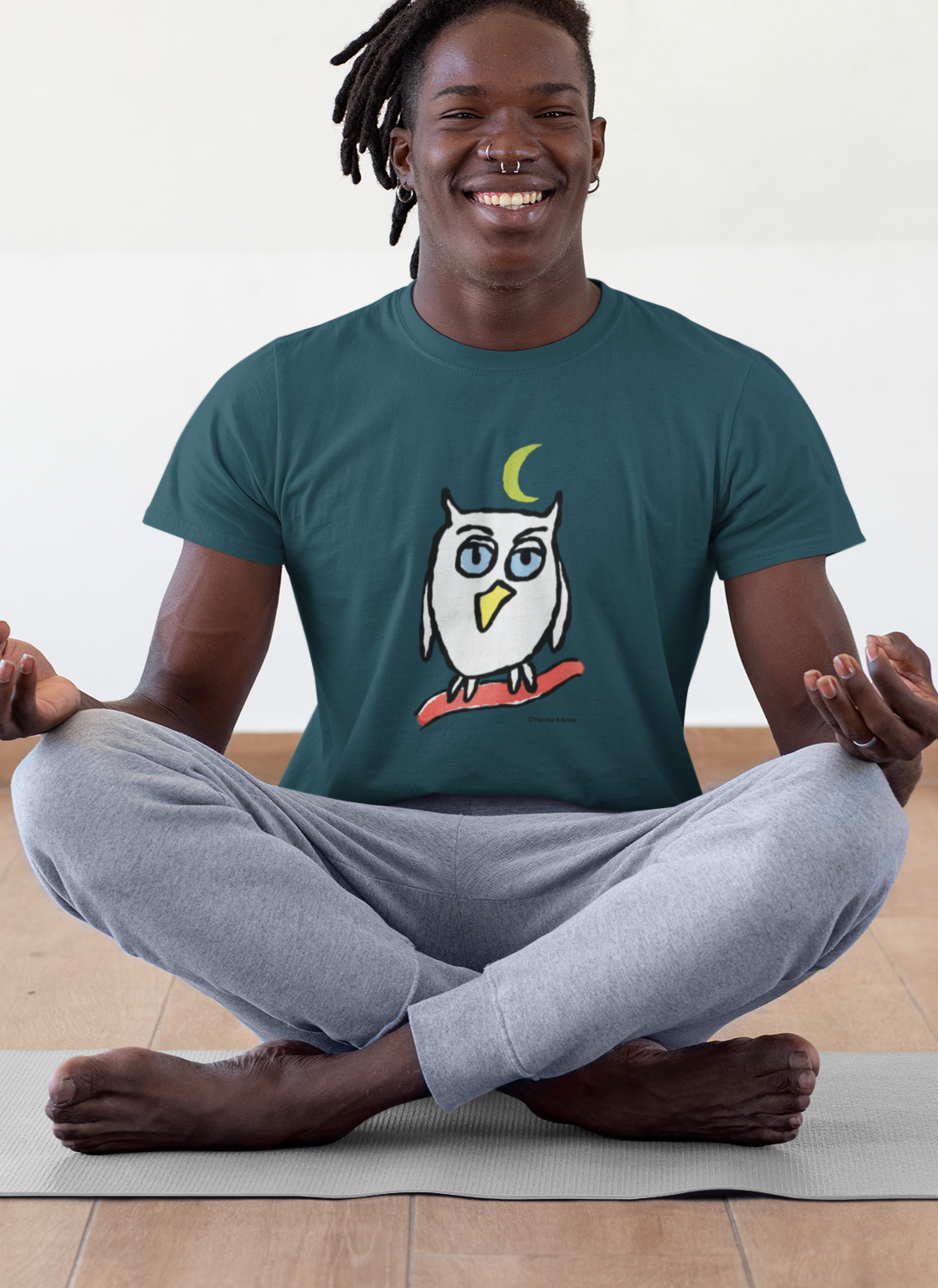 Owl T-shirts - Young man wearing a night blue colour vegan cotton Night Owl T-shirt design by Hector and Bone