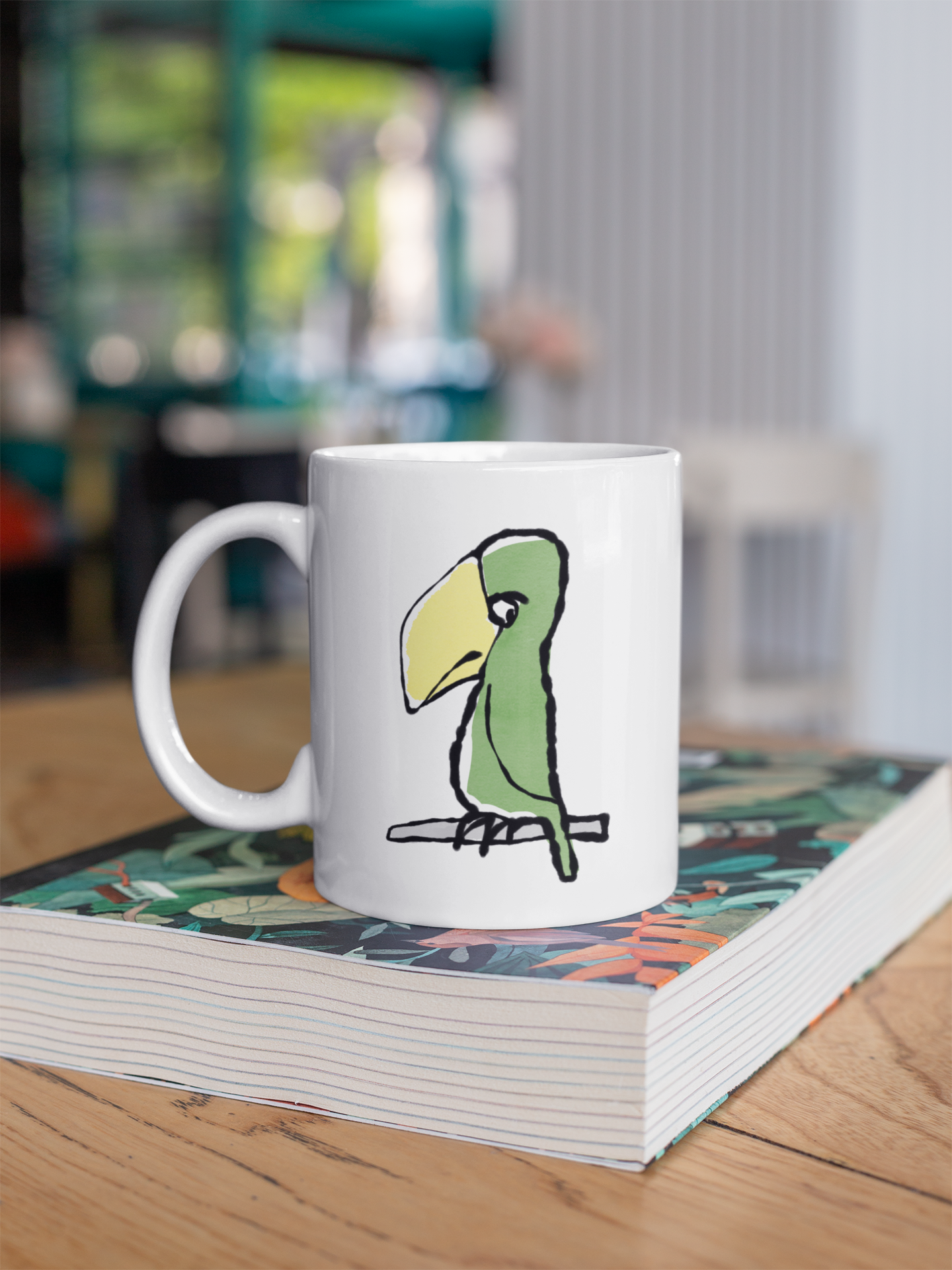 Funny Peter Parrot mug - Original Illustrated Parrot design on a coffee mug by Hector and Bone on a table