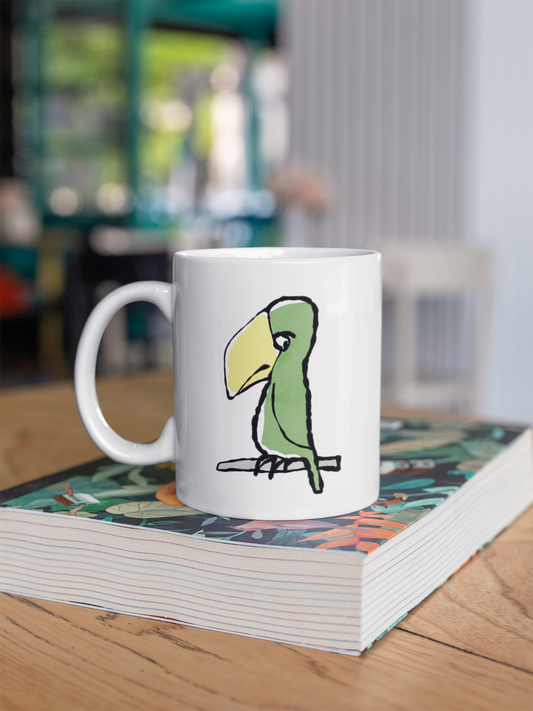 Funny Peter Parrot mug - Original Illustrated Parrot design on a coffee mug by Hector and Bone on a table