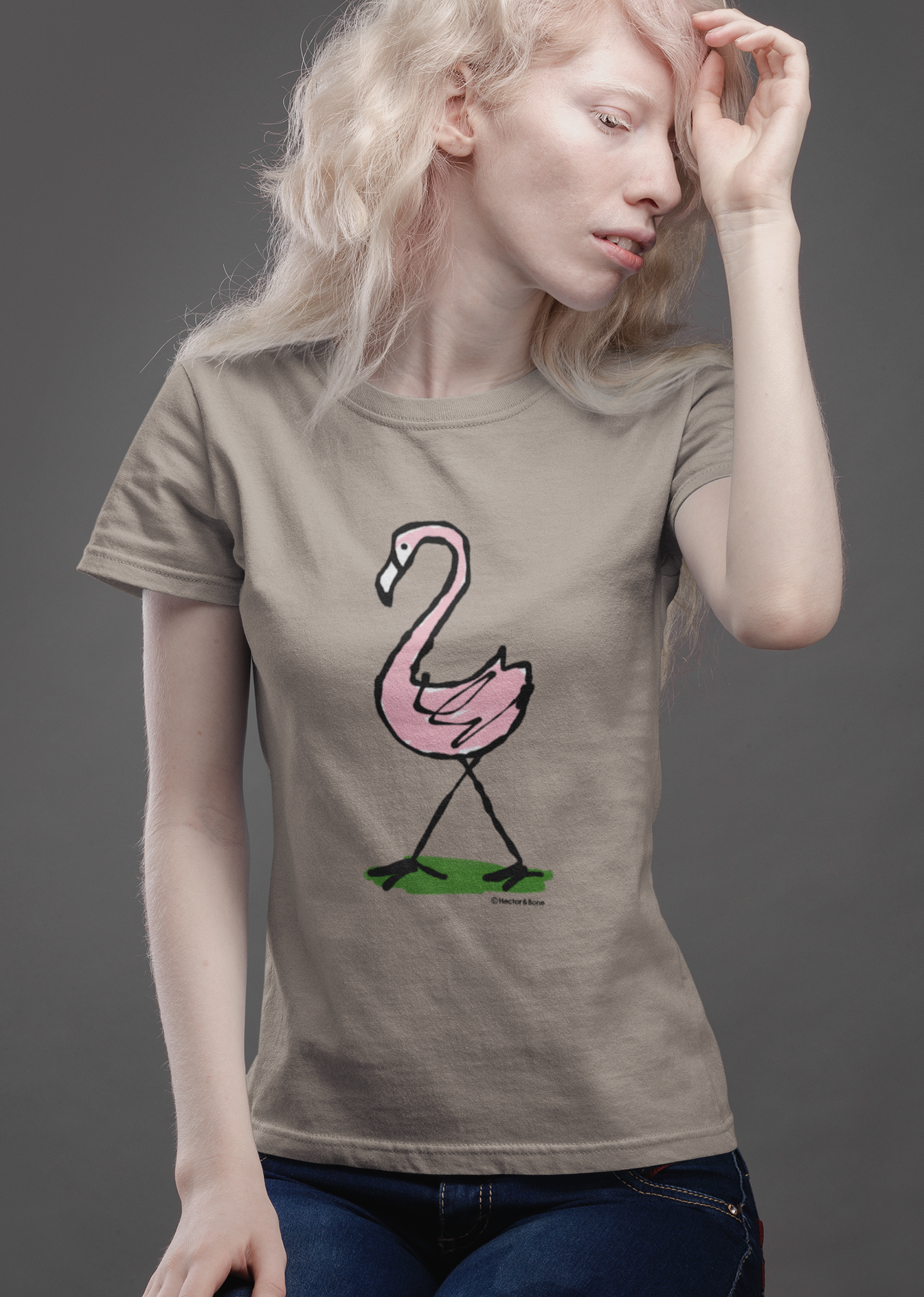 Pink Flamingo T-shirt - Young woman wearing an illustrated flamingo t-shirt design on sand tee by Hector and Bone
