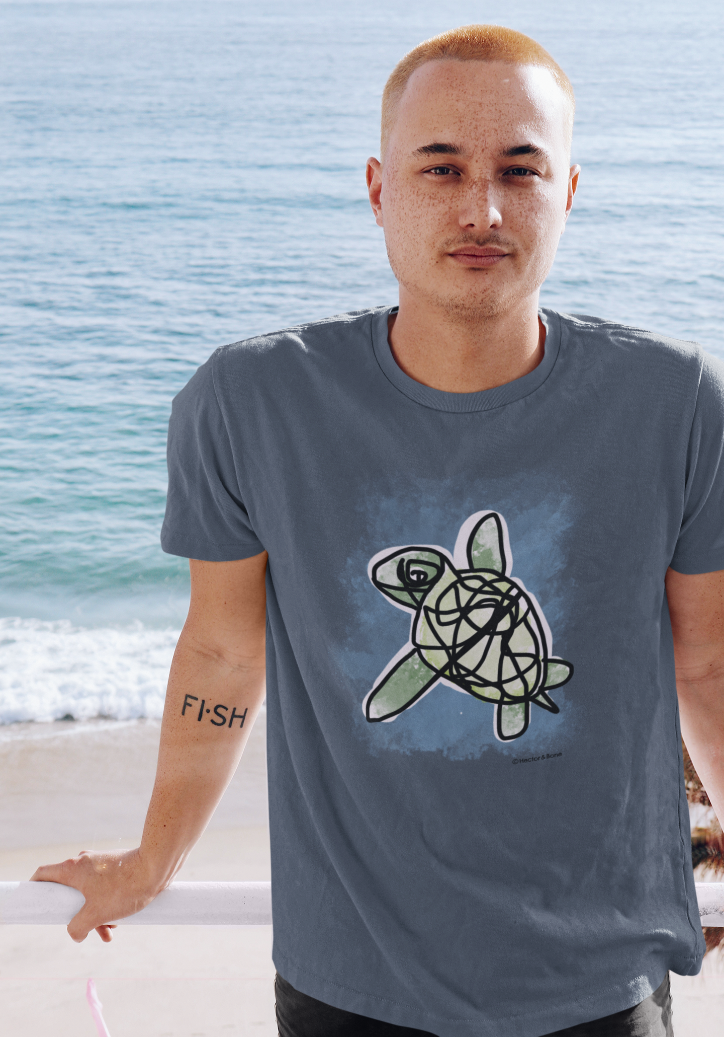 Sea Turtle T-shirt - Young man wearing an illustrated green sea turtle t-shirt by Hector and Bone