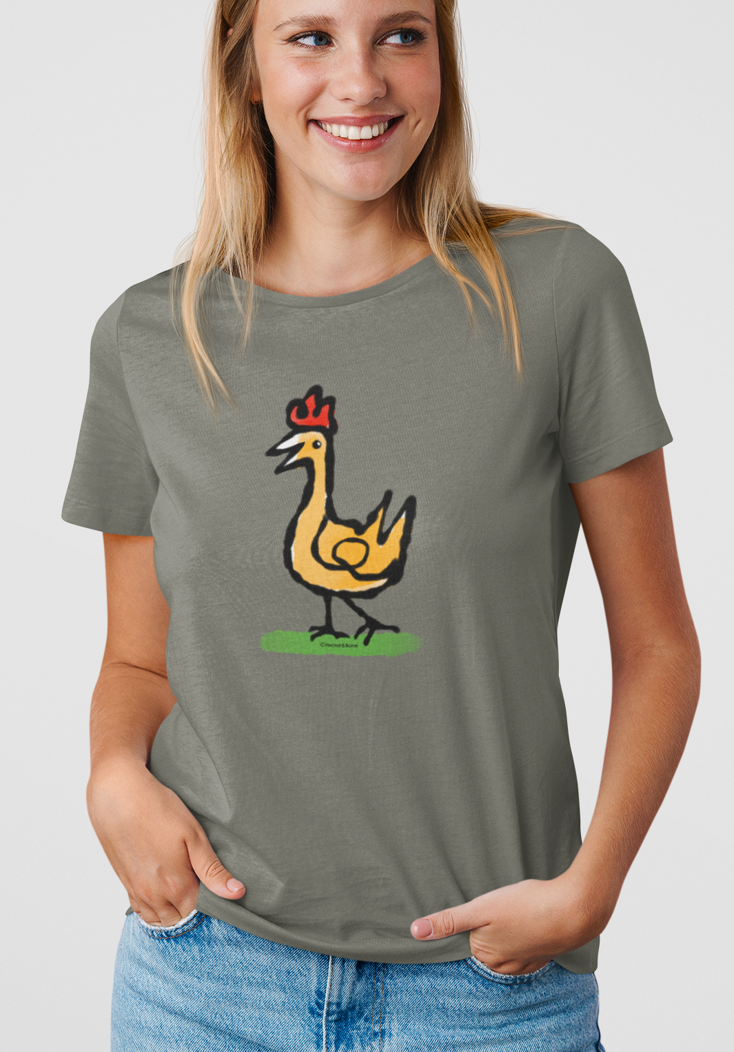 Happy Chicken T-shirt - Smiling young woman wearing Illustrated Funny Chicken design on khaki colour vegan cotton t-shirts by Hector and Bone