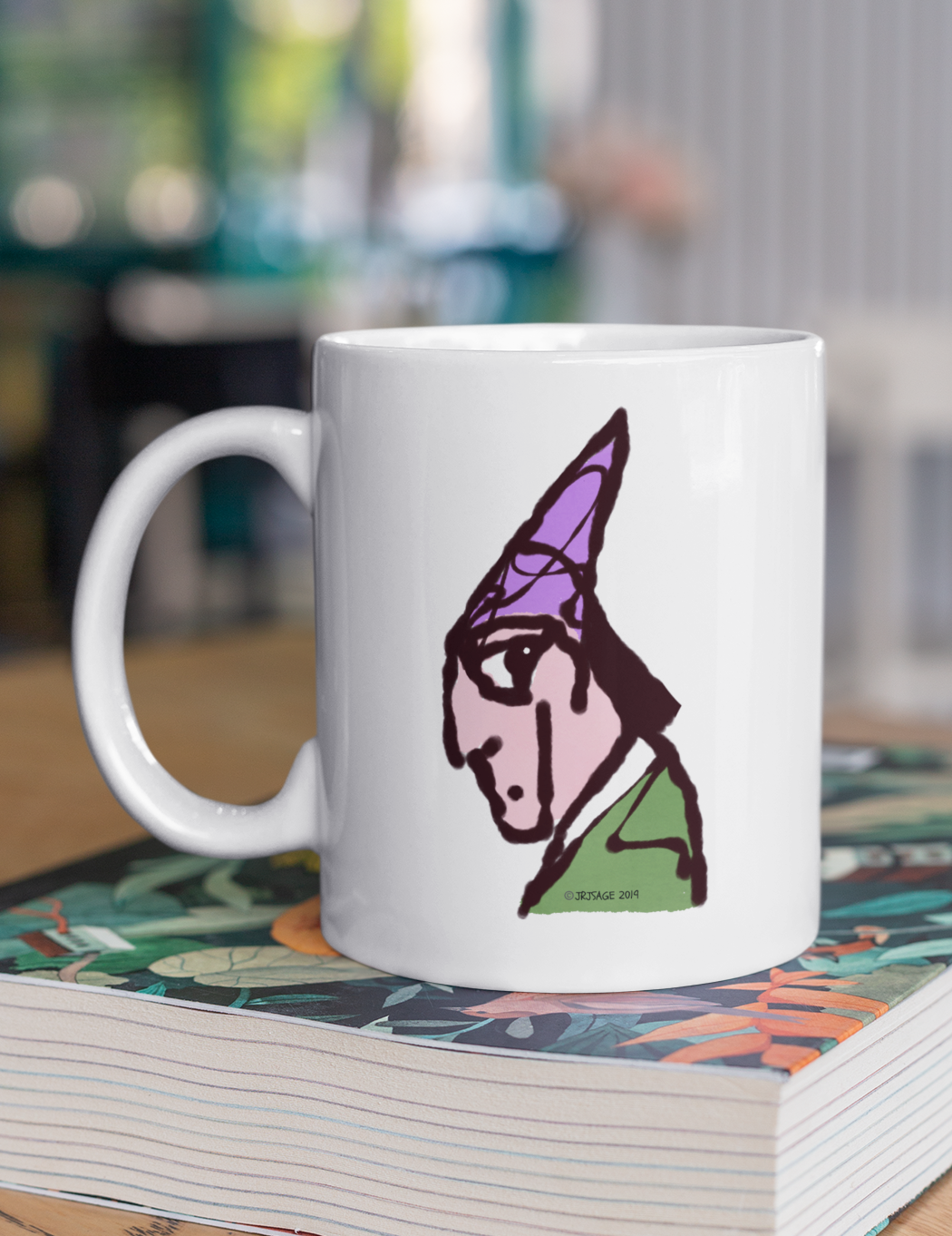Wizard coffee mug - Illustrated magicial wizard design on a mug by Hector and Bone on a table
