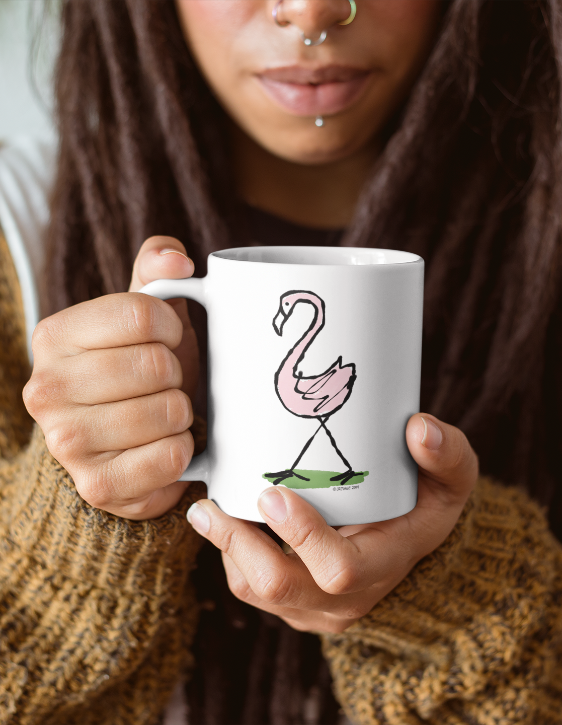 A woman holding a White Ceramic Hector and Bone Mug with an illustration of a cute Pink Flamingo