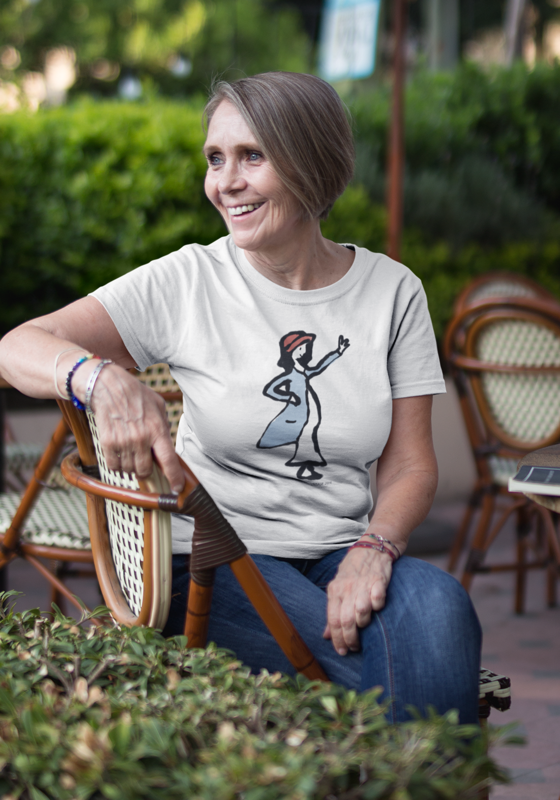 A woman wearing a vegan cotton t-shirt with printed illustration of a waving girl design by hector and bone