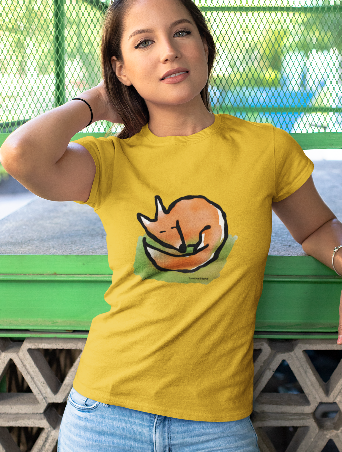 Young woman wears a cute Sleeping Fox illustrated yellow cotton T-shirt. Original fox design by Hector and Bone