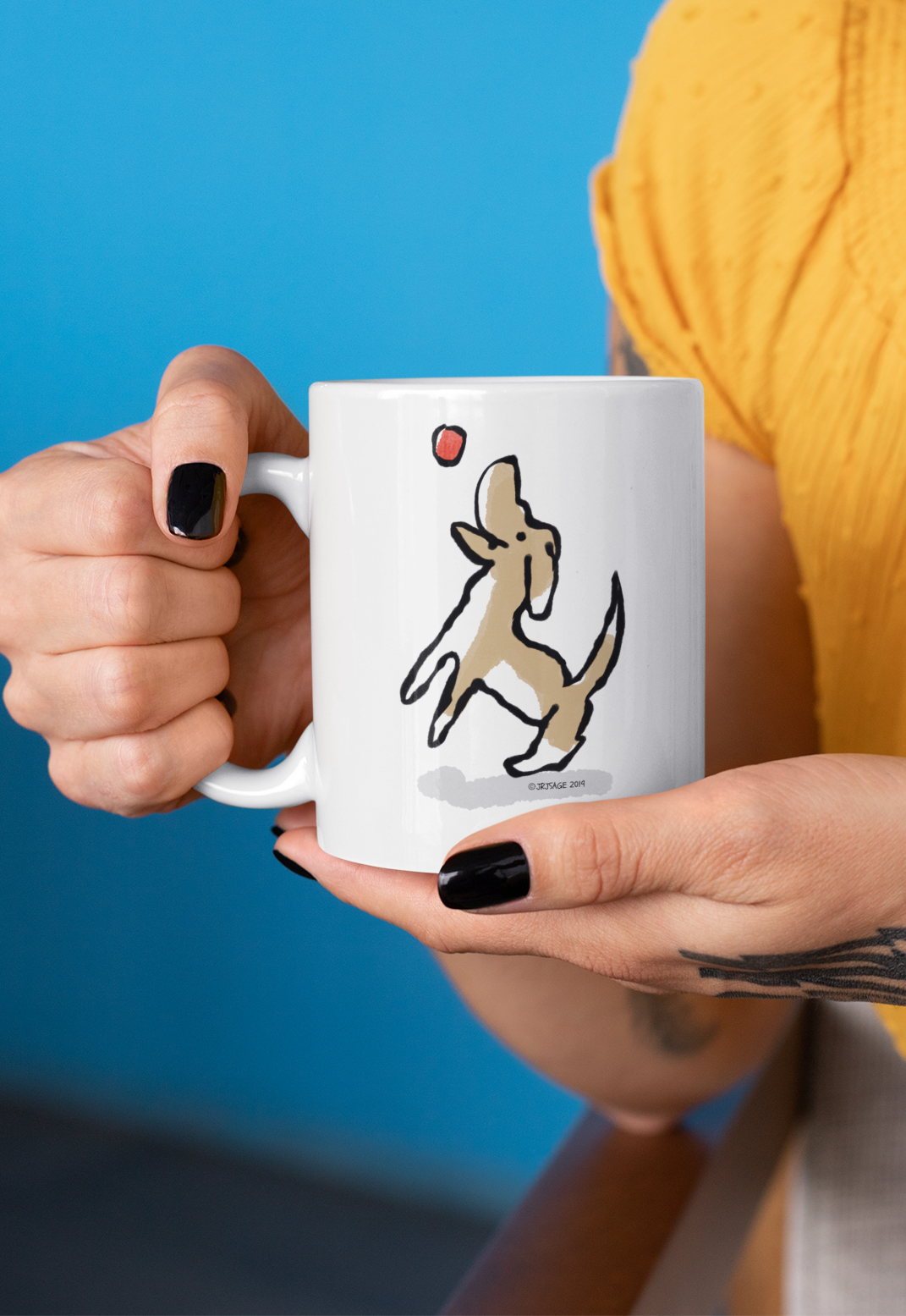 A woman holding a White Hector and Bone Mug with illustration of a Cute Jumping Do