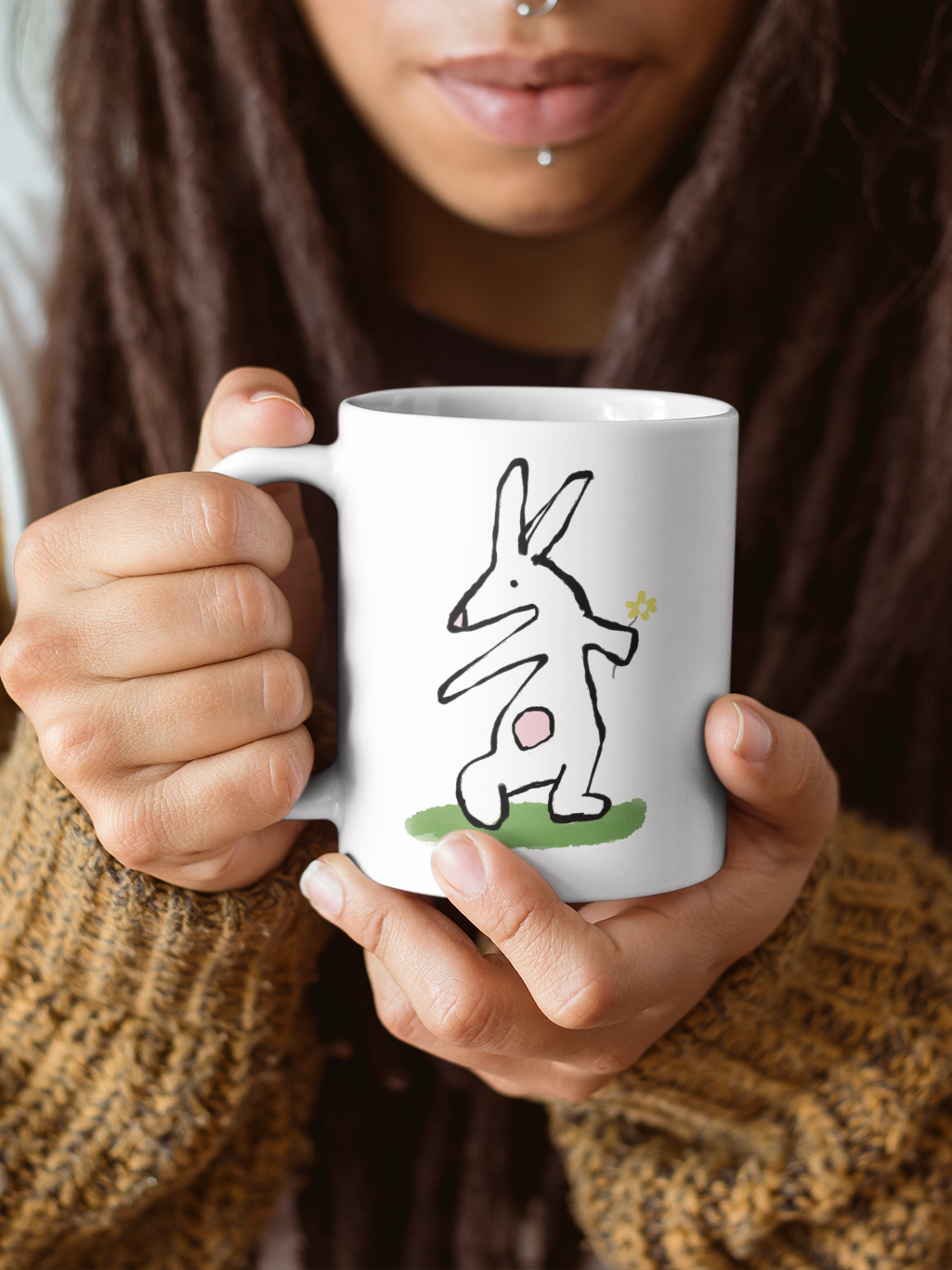 Young woman holding an Illustrated Rabbit Flower Bunny mug by Hector and Bone
