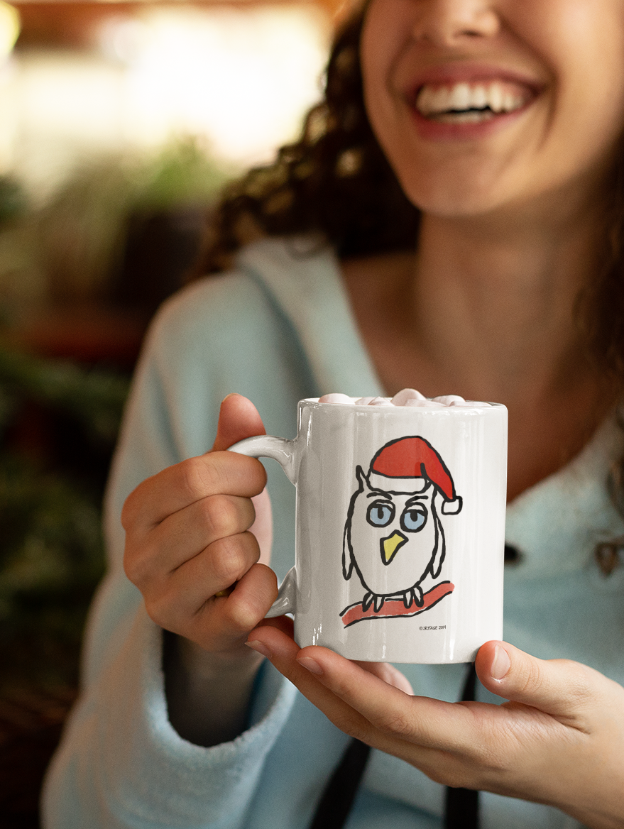 Woman holding Santa Night Owl Christmas coffee mug design by Hector and Bone cute animal wearing Xmas hat