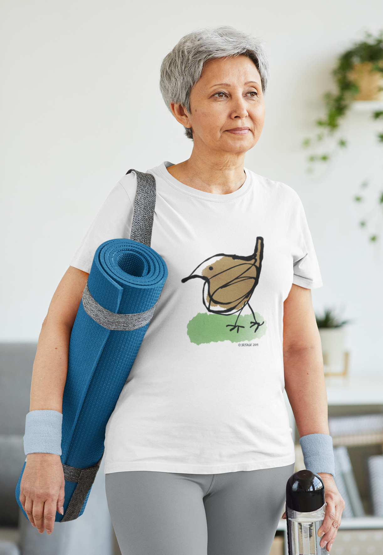 Yoga woman wearing a cotton t-shirt with a printed hand drawn cute jenny wren bird design by hector and bone