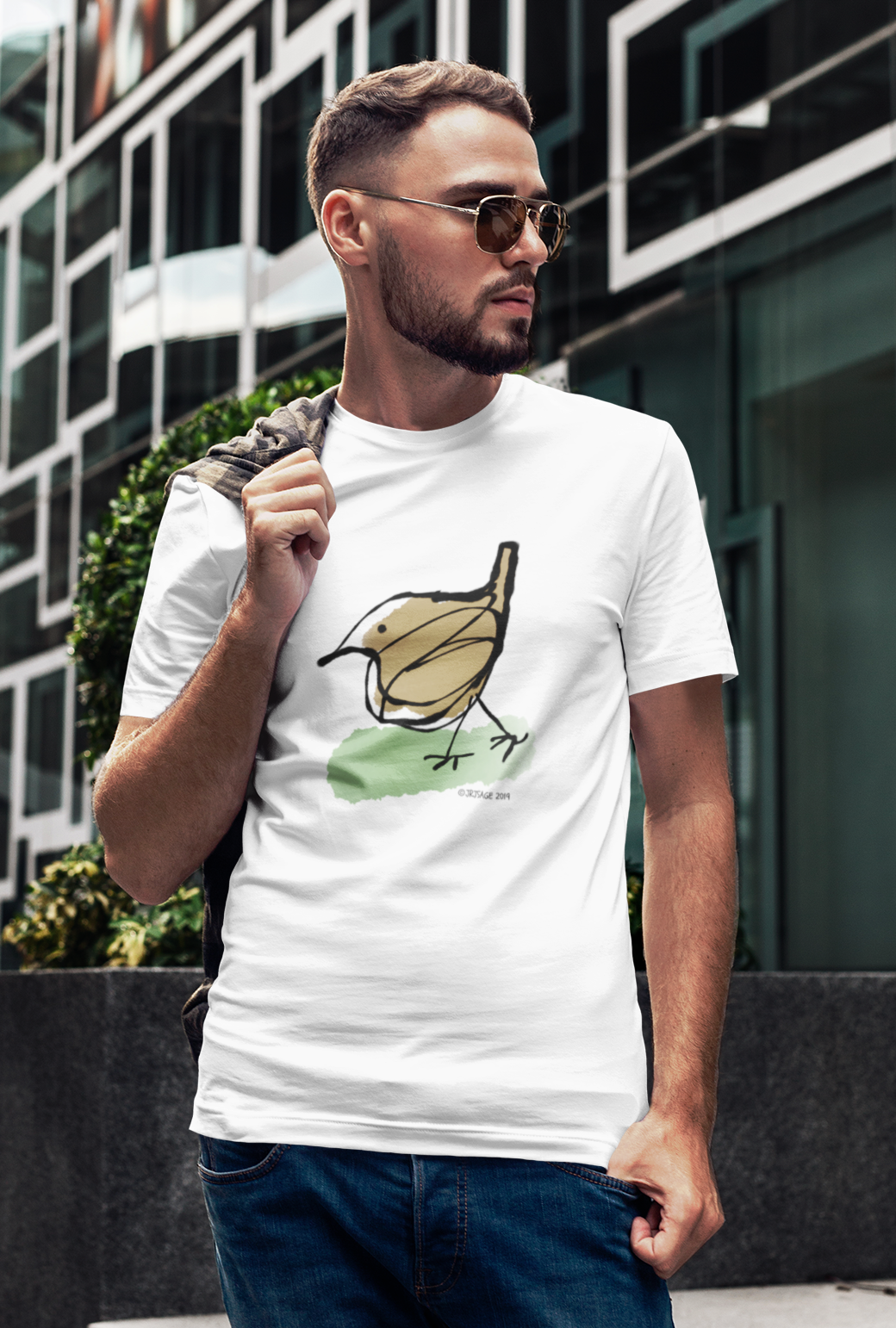 Young man wearing a cotton t-shirt with a printed hand drawn cute jenny wren bird design by hector and bone