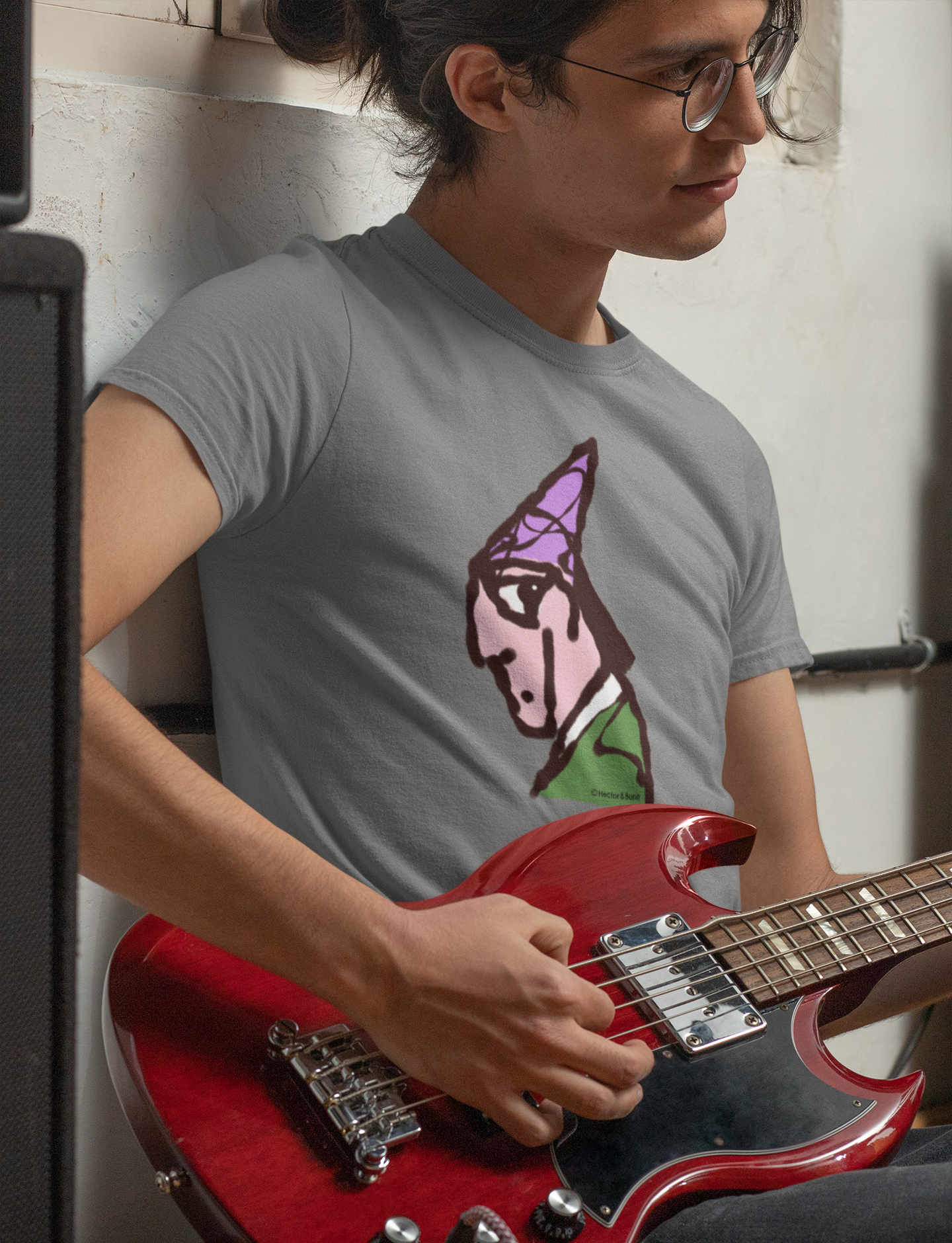 Wizard T-shirt - Young man playing a bass guitar wearing a illustrated magical wizard t-shirt in mid heather grey colour vegan cotton by Hector and Bone 