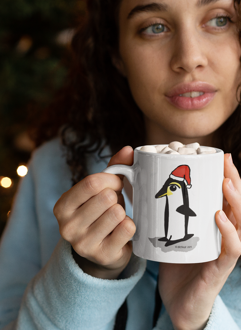 Young woman holding Santa Penguin Christmas mug design by Hector and Bone cute animal wearing Xmas hat
