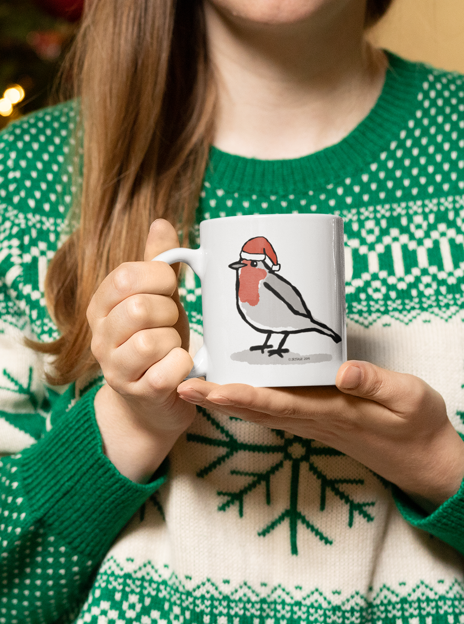 Woman holding a Santa Robin Christmas mug design by Hector and Bone cute Robin bird wearing an Xmas hat