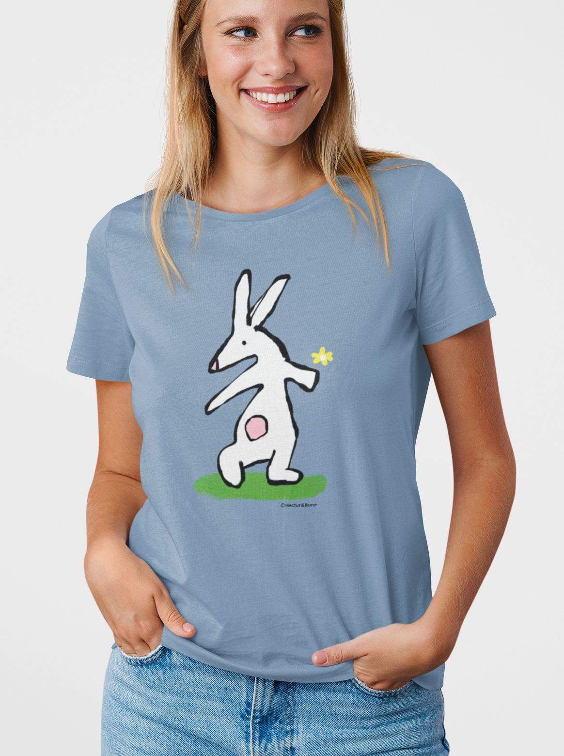 Bunny T-shirt - Young woman wearing Illustrated rabbit holding a flower design on a mid heather blue vegan cotton t-shirt - Easter Bunny t-shirts by Hector and Bone