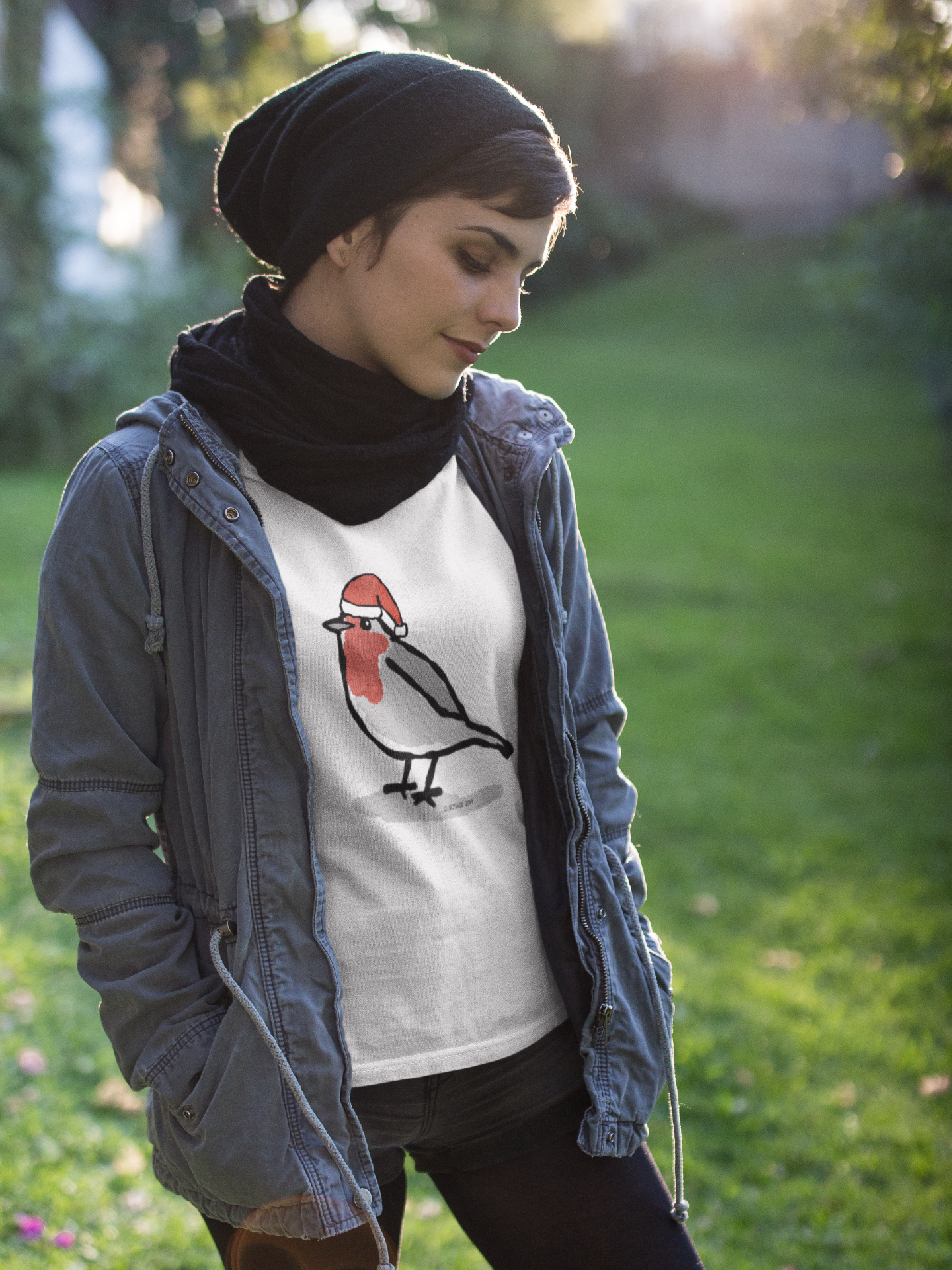 Girl wearing a Santa Robin cute Christmas T-shirt illustrated design by Hector and Bone on a vegan cotton t-shirt