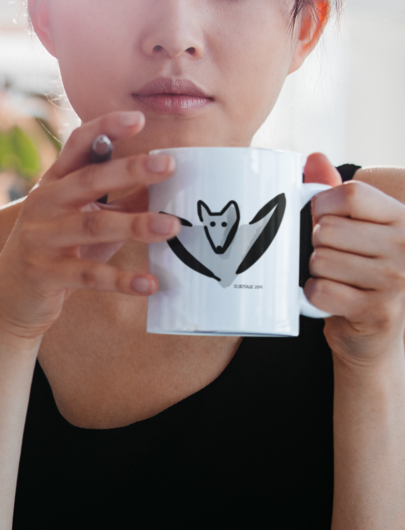 Woman holding a Cute Bertie Bat illustrated Halloween coffee mug by Hector and Bone
